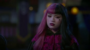 Movie still from “Monster High: The Movie” (2022), directed by Todd Holland – A woman with pink and black hair wearing a pink and black outfit; Close Up shot, Over the shoulder angle