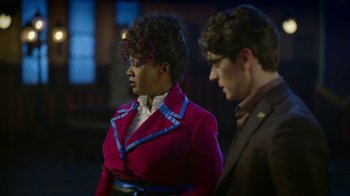 Movie still from “Monster High: The Movie” (2022), directed by Todd Holland – A woman and a man standing next to each other; Medium shot, Over the shoulder angle