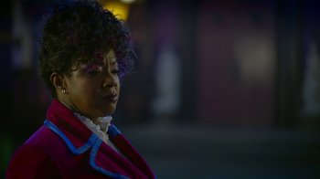 Movie still from “Monster High: The Movie” (2022), directed by Todd Holland – A person with curly hair wearing a dress; Close Up shot, Over the shoulder angle