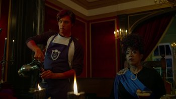 Movie still from “Monster High: The Movie” (2022), directed by Todd Holland – A man and a woman standing in front of lit candles; Medium shot, Over the shoulder angle