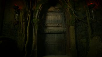 Movie still from “Monster High: The Movie” (2022), directed by Todd Holland – An old wooden door in the middle of a forest; Wide shot, Low angle