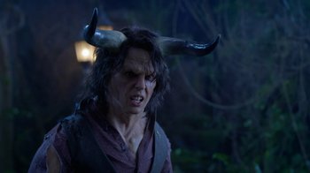 Movie still from “Monster High: The Movie” (2022), directed by Todd Holland – A man with a horned hat on his head; Close Up shot, Over the shoulder angle