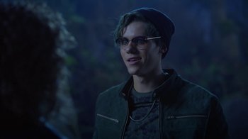 Movie still from “Monster High: The Movie” (2022), directed by Todd Holland – A young man wearing glasses and a hat; Close Up shot, Over the shoulder angle