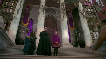 Movie still from “Monster High: The Movie” (2022), directed by Todd Holland – A group of people standing in front of a building; Wide shot, Low angle