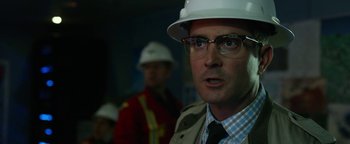 Movie still from “Monster Trucks” (2016), directed by Chris Wedge – A person wearing glasses and a hard hat; Close Up shot, Over the shoulder angle
