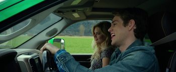 Movie still from “Monster Trucks” (2016), directed by Chris Wedge – A man and a woman in the driver's seat of a car; Close Up shot, Low angle