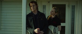 Movie still from “Monster Trucks” (2016), directed by Chris Wedge – A man and a woman standing next to each other; Medium shot, Over the shoulder angle