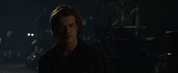 Movie still from “Monster Trucks” (2016), directed by Chris Wedge – A man with long hair standing in the dark; Close Up shot, Low angle