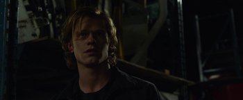 Movie still from “Monster Trucks” (2016), directed by Chris Wedge – A man with blonde hair is looking at the camera; Close Up shot, Low angle