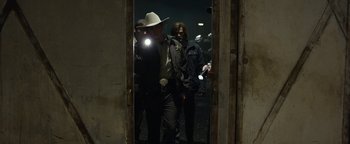 Movie still from “Monster Trucks” (2016), directed by Chris Wedge – A group of men standing next to each other in front of a mirror; Medium shot, Over the shoulder angle