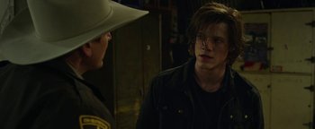 Movie still from “Monster Trucks” (2016), directed by Chris Wedge – A man in a cowboy hat talking to another man in a cowboy hat; Close Up shot, Over the shoulder angle