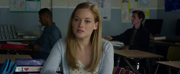 Movie still from “Monster Trucks” (2016), directed by Chris Wedge – A woman sitting at a table in front of a wall; Close Up shot, Over the shoulder angle