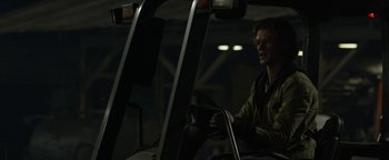 Movie still from “Monster Trucks” (2016), directed by Chris Wedge – A man sitting in the driver's seat of a vehicle; Medium shot, Over the shoulder angle
