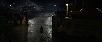 Movie still from “Monster Trucks” (2016), directed by Chris Wedge – A woman walking down a street at night; Extreme Wide shot, High angle