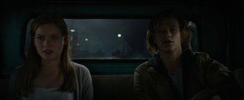 Movie still from “Monster Trucks” (2016), directed by Chris Wedge – A man and a woman sitting on a bench; Medium shot, Low angle