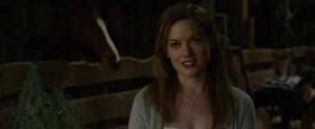 Movie still from “Monster Trucks” (2016), directed by Chris Wedge – A beautiful young woman with long brown hair and blue eyes; Close Up shot, Over the shoulder angle