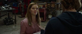 A woman sitting in front of another woman