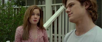 Movie still from “Monster Trucks” (2016), directed by Chris Wedge – A woman standing next to a man on a porch; Close Up shot, Over the shoulder angle