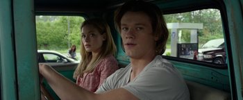 Movie still from “Monster Trucks” (2016), directed by Chris Wedge – A man and a woman sitting in the back of a car; Close Up shot, Over the shoulder angle