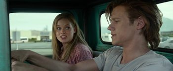 Movie still from “Monster Trucks” (2016), directed by Chris Wedge – A man and a woman sitting in a car; Close Up shot, Over the shoulder angle