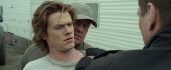 Movie still from “Monster Trucks” (2016), directed by Chris Wedge – A man and a boy are standing next to each other; Close Up shot, Over the shoulder angle