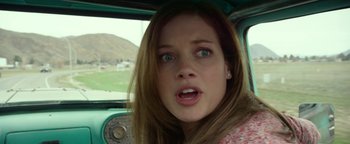 Movie still from “Monster Trucks” (2016), directed by Chris Wedge – A young woman in a car looking at the camera; Close Up shot, Over the shoulder angle