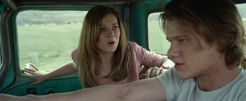 Movie still from “Monster Trucks” (2016), directed by Chris Wedge – A young woman sitting in the back of a vehicle; Close Up shot, Over the shoulder angle