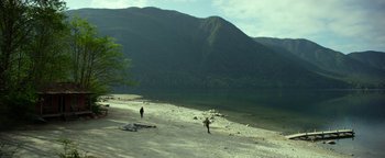 Movie still from “Monster Trucks” (2016), directed by Chris Wedge – Two people walking on a beach near a body of water; Extreme Wide shot, High angle