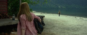 Movie still from “Monster Trucks” (2016), directed by Chris Wedge – A woman sitting on a bench on the beach; Wide shot, Over the shoulder angle