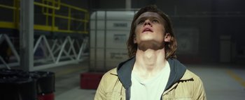 Movie still from “Monster Trucks” (2016), directed by Chris Wedge – A young man looking up into the sky; Close Up shot, Low angle