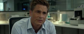 Movie still from “Monster Trucks” (2016), directed by Chris Wedge – A person sitting in a chair wearing a dress shirt; Close Up shot, Over the shoulder angle