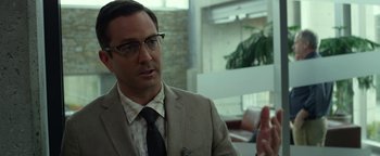 Movie still from “Monster Trucks” (2016), directed by Chris Wedge – A man in a suit and tie talking to someone; Close Up shot, Over the shoulder angle