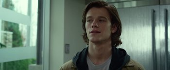Movie still from “Monster Trucks” (2016), directed by Chris Wedge – A man with long brown hair is looking to his left; Close Up shot, Low angle