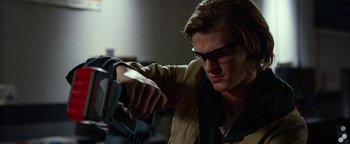 Movie still from “Monster Trucks” (2016), directed by Chris Wedge – A young man holding a pair of glasses and looking at a camera; Close Up shot, Low angle