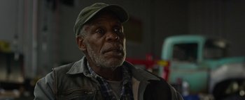 Movie still from “Monster Trucks” (2016), directed by Chris Wedge – An older man wearing a hat and looking up; Close Up shot, Low angle