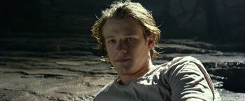 Movie still from “Monster Trucks” (2016), directed by Chris Wedge – A man with long blonde hair is posing for a picture; Close Up shot, Low angle