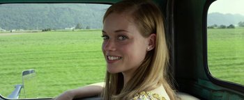 Movie still from “Monster Trucks” (2016), directed by Chris Wedge – A young woman sitting in the driver's seat of a car; Close Up shot, Over the shoulder angle