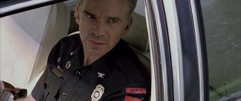 Movie still from “Monster's Ball” (2001), directed by Marc Forster – A police officer sitting in the back of a car; Close Up shot, Low angle