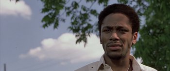 Movie still from “Monster's Ball” (2001), directed by Marc Forster – A person with a tree in the background; Close Up shot, Low angle