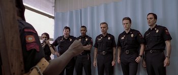 Movie still from “Monster's Ball” (2001), directed by Marc Forster – A group of men in police uniforms posing for a picture; Medium shot, Low angle