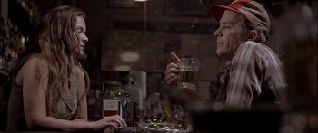 Movie still from “Monster's Ball” (2001), directed by Marc Forster – Two people sitting at a table with a drink; Medium shot, Over the shoulder angle