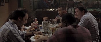 Movie still from “Monster's Ball” (2001), directed by Marc Forster – A group of people sitting at a table with drinks; Medium shot, Over the shoulder angle