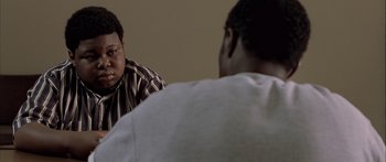 Movie still from “Monster's Ball” (2001), directed by Marc Forster – Two men sitting in front of each other in front of a wall; Close Up shot, Over the shoulder angle