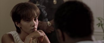 Movie still from “Monster's Ball” (2001), directed by Marc Forster – A woman smoking a cigarette in front of another person; Close Up shot, Over the shoulder angle