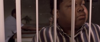 Movie still from “Monster's Ball” (2001), directed by Marc Forster – A person behind bars in a jail cell; Close Up shot, Low angle