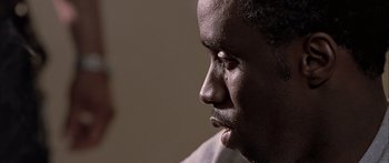 Movie still from “Monster's Ball” (2001), directed by Marc Forster – A man's face in a dark room; Close Up shot, Over the shoulder angle