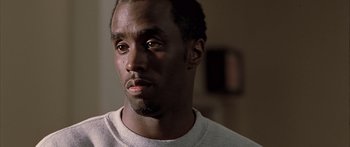 Movie still from “Monster's Ball” (2001), directed by Marc Forster – A person wearing a white t - shirt; Close Up shot, Over the shoulder angle