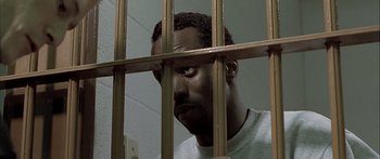 Movie still from “Monster's Ball” (2001), directed by Marc Forster – A man in a jail cell looking through the bars; Close Up shot, High angle