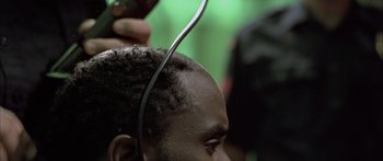 Movie still from “Monster's Ball” (2001), directed by Marc Forster – A man getting his hair combed by a barber; Close Up shot, Over the shoulder angle