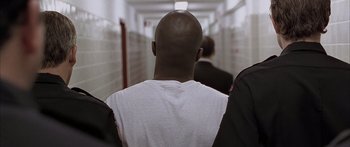 Movie still from “Monster's Ball” (2001), directed by Marc Forster – The back of a man's head as he walks down a hallway; Close Up shot, Over the shoulder angle